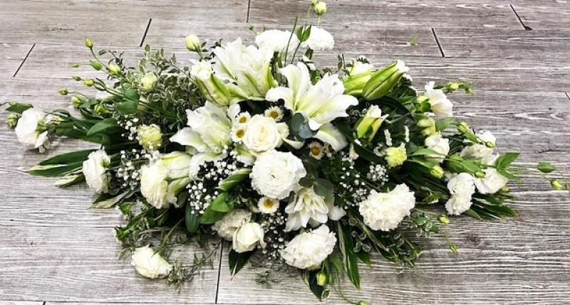 White mixed blooms casket spray